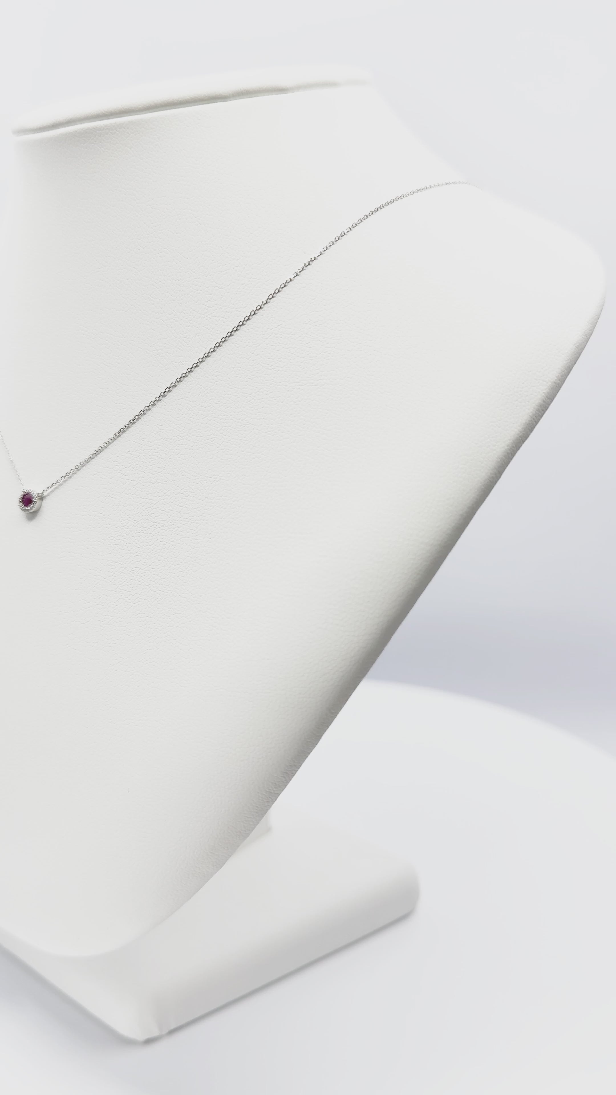 Load video: Oval Ruby and Diamond Halo Necklace in 14K White Gold